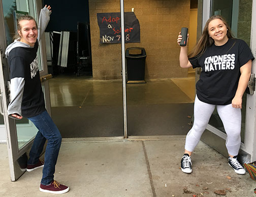 Students greeting people in the morning.