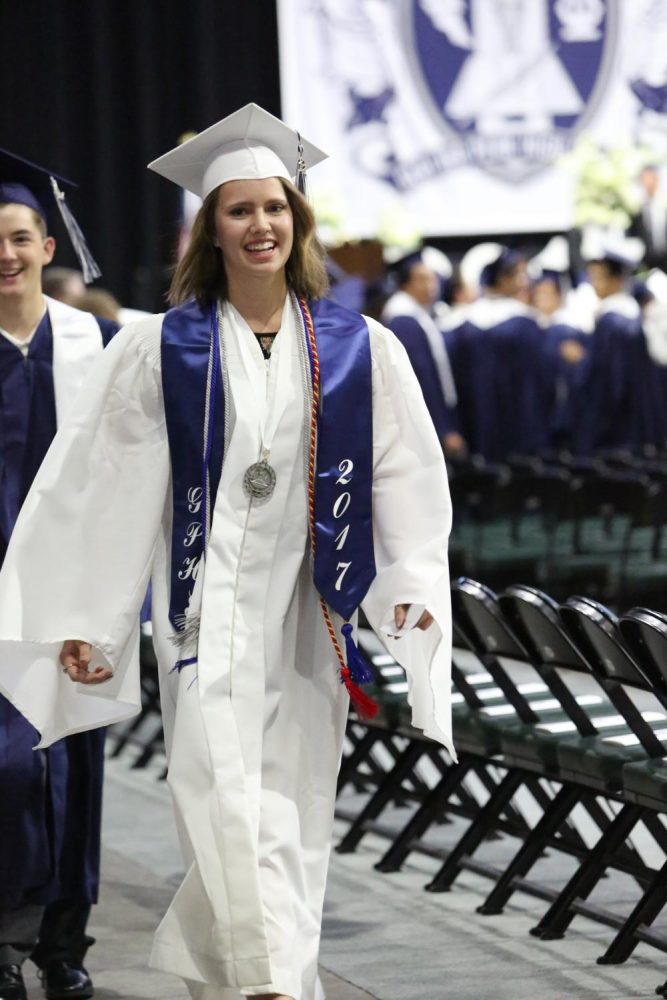 Nicole+Hehn+walking+in+her+cap+and+gown.