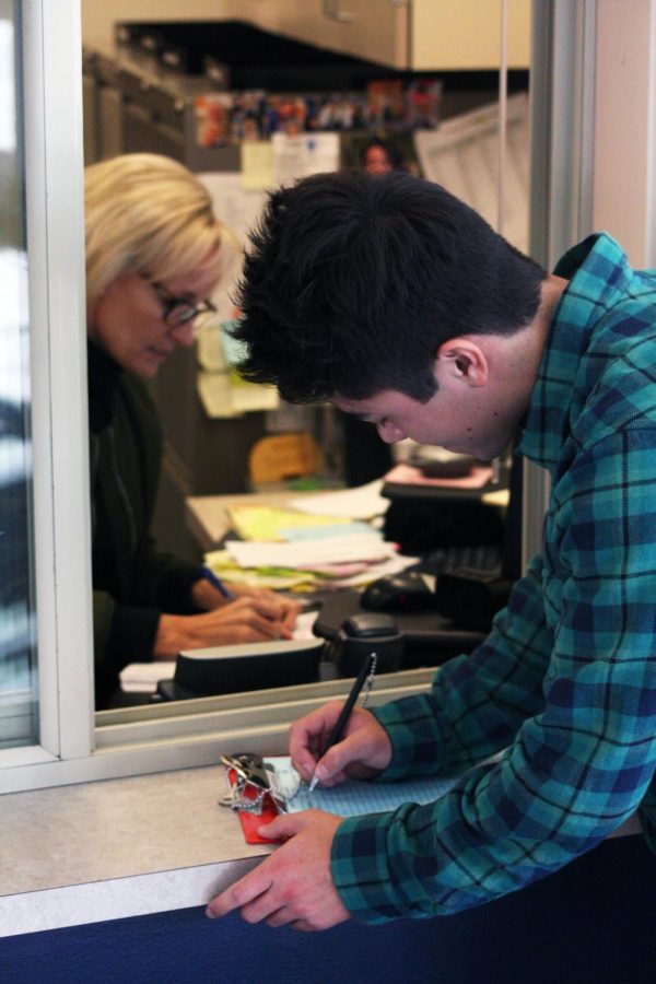 A student checking in at the attendance office.