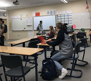 Students start filling in to Chinese class to get ready to learn. 