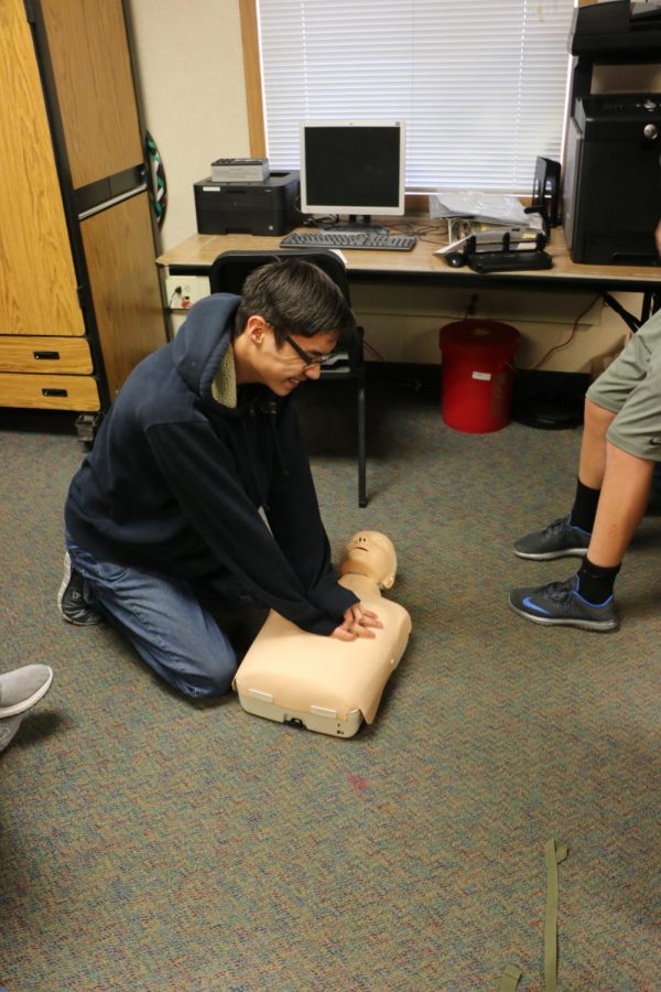 Freshman Keenan Wiggins tries to keep Devin the Dummy alive.