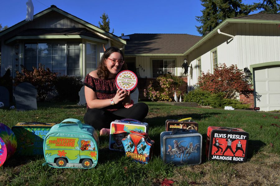 Madison in front of her house with some of her lunchboxes.
