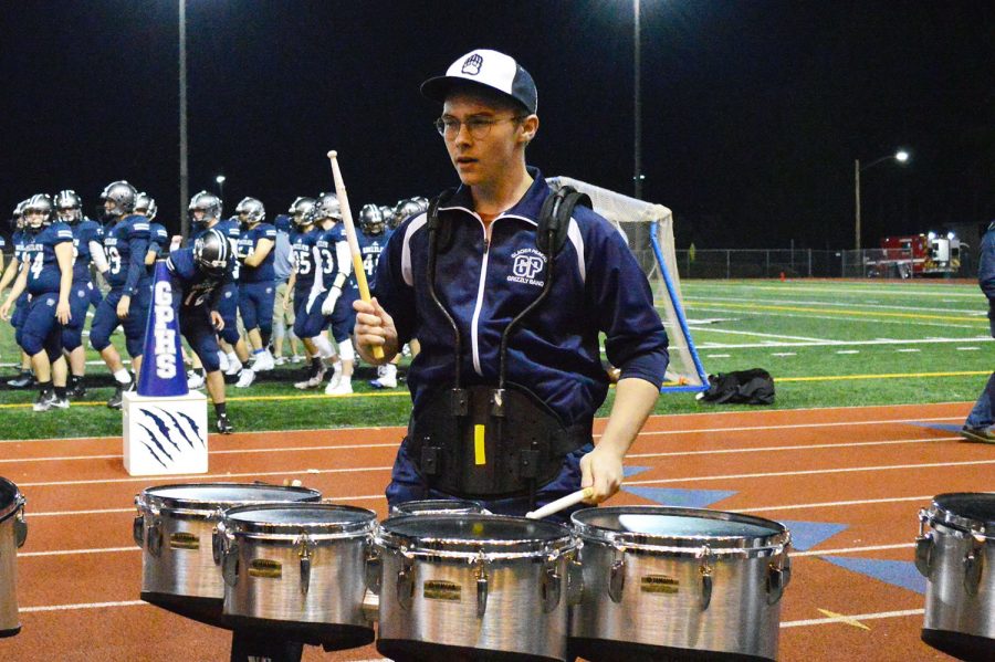 Gavin playing his drums at a football game.