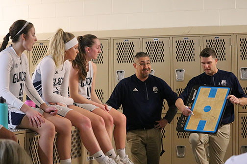 Coach Hill goes over the second half game plan during half-time. 