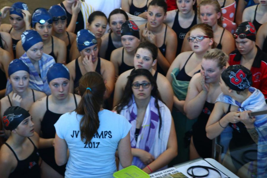 Glacier Peak and Snohomish gathering with assistant coach, Jenny Service, before a meet.