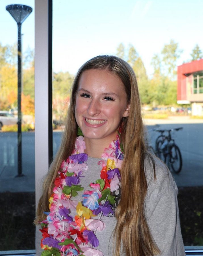 Cheer captain, Lizzy Carlson, smiles wide. 