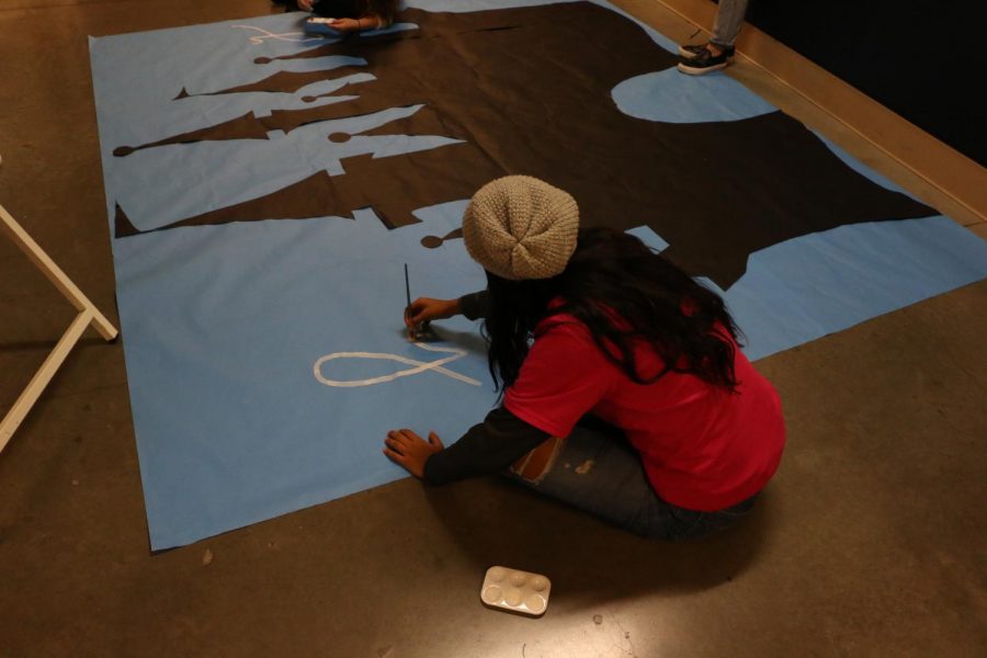 Jomary Loympio works on a castle poster to show our homecoming Disney theme.