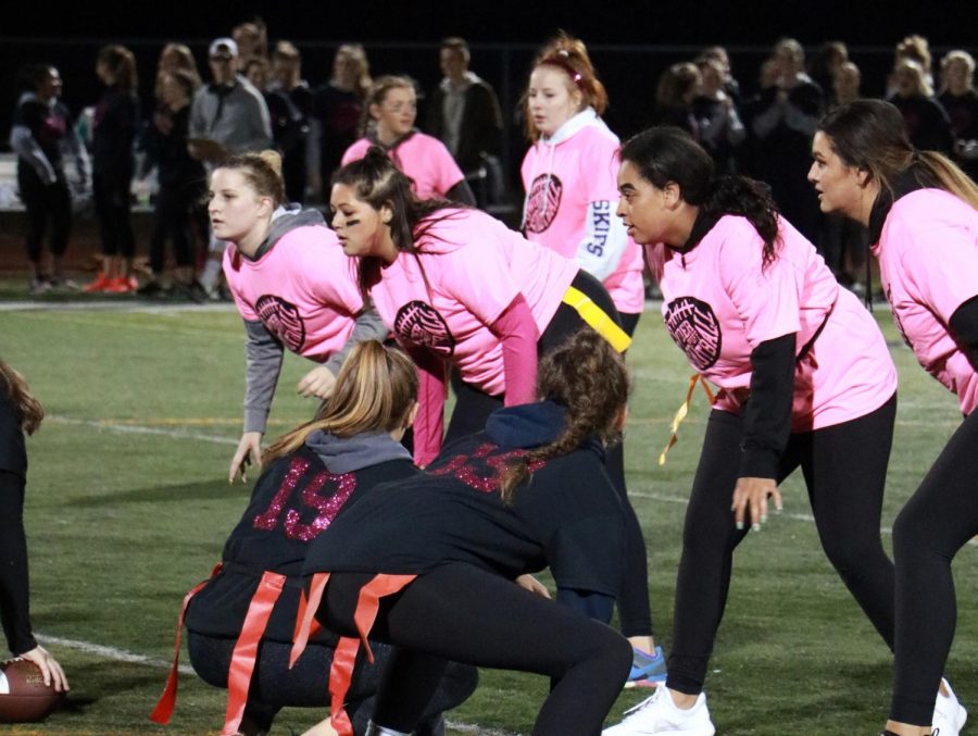 Juniors and seniors prepare to start a play in the 2017 powderpuff game.