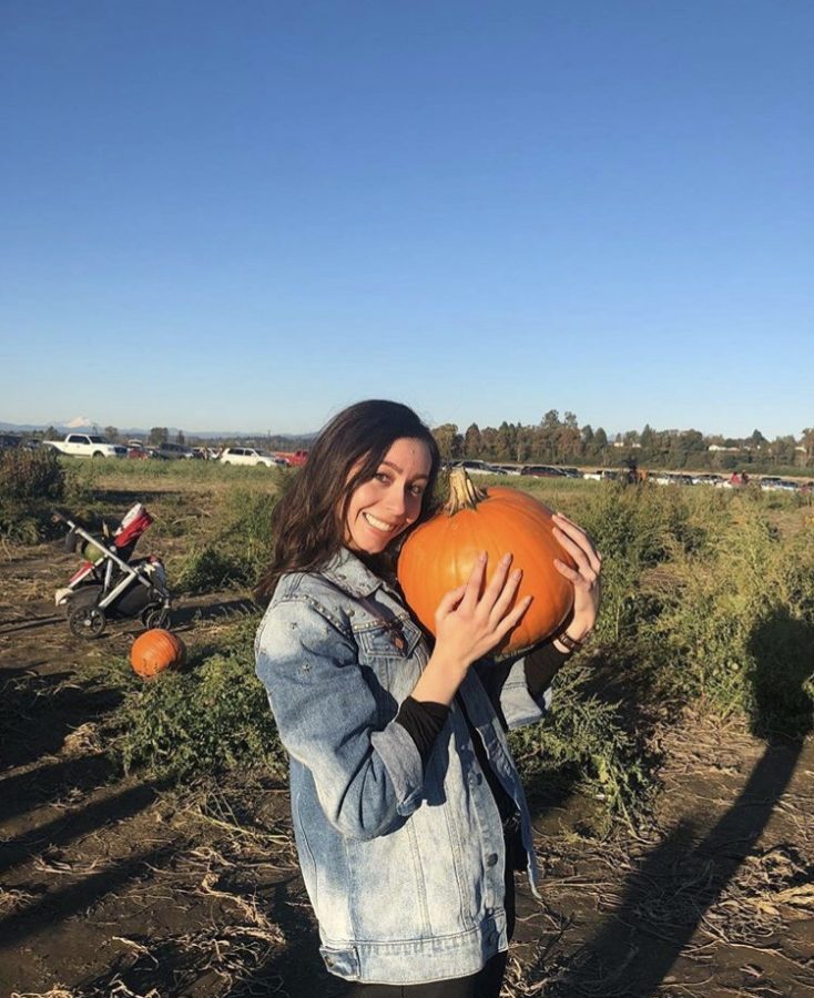 Senior Jane Bekker holding a pumpkin at Swans Trail Farms.
Credit: @jane.bekker, Instagram