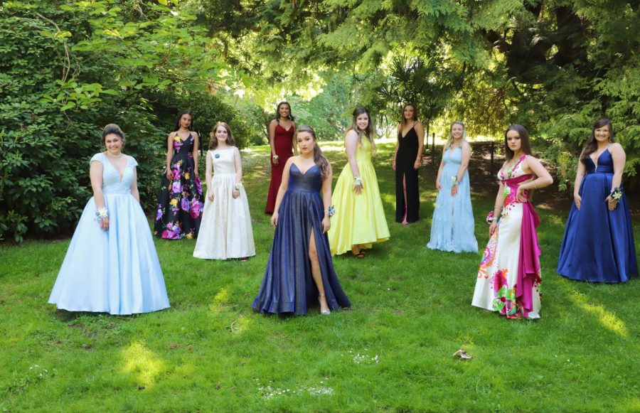 A group of girls pose in their unique dresses for prom pictures.