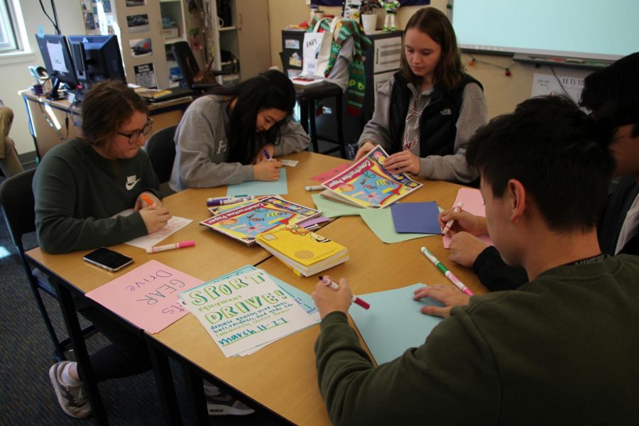 Students working on posters for the Key club sports equipment drive