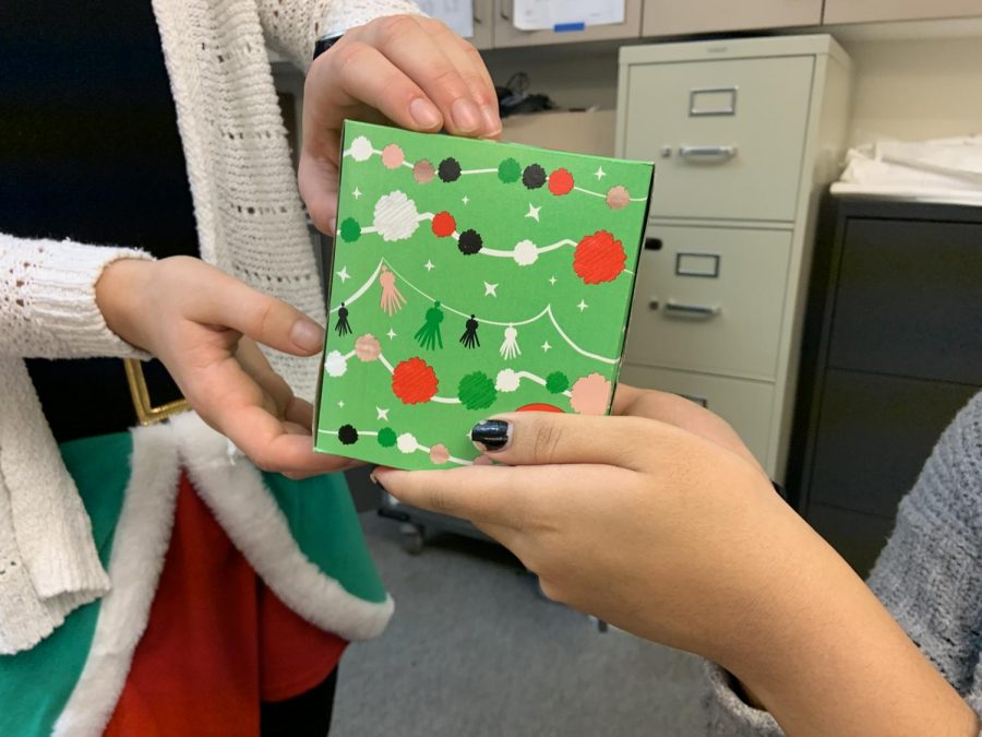 A student gives a teacher a present. 