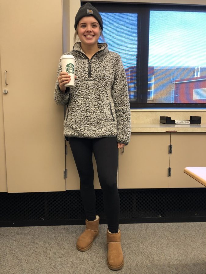 Kaylee wearing the Classic Mini Uggs, a Carhartt Beanie, drinking a warm oat milk latte.