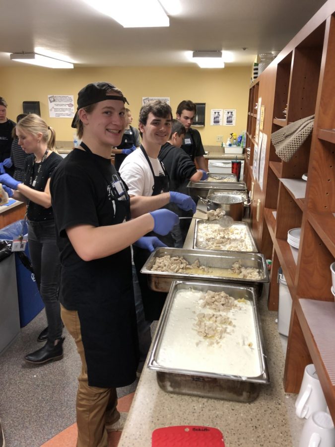 Seniors, Nic Hines, Ryan Halverson and Tristan Hawk preparing the food.