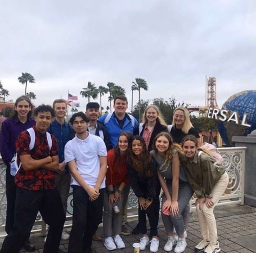 The+group+that+went+on+the+trip+pose+for+a+picture+in+front+of+the+Universal+Studios+globe.